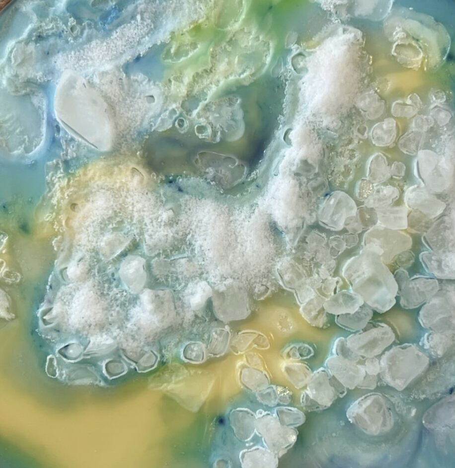 mage of light blue salt crystals that form into an artistic looking layer.